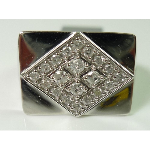 834 - A gentleman's 9ct white gold and diamond ring, comprising four pave set diamonds with a border of 16... 