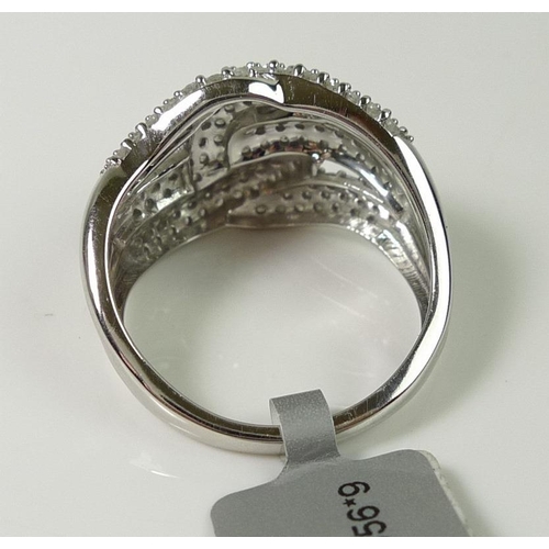 838 - A 9ct white gold and diamond dress ring, pave set with diamond chips in a knot design, size S, 6.4g,... 