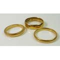 A group of three 22ct gold wedding bands, sizes Q, Q1/2 and K, 17.2g total weight. (3)