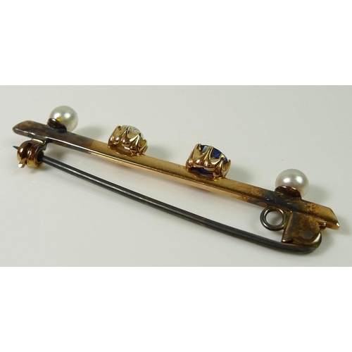 844 - A gold bar brooch set with an old rose cut diamond, approx 0.45ct, a sapphire, and two white pearls,... 