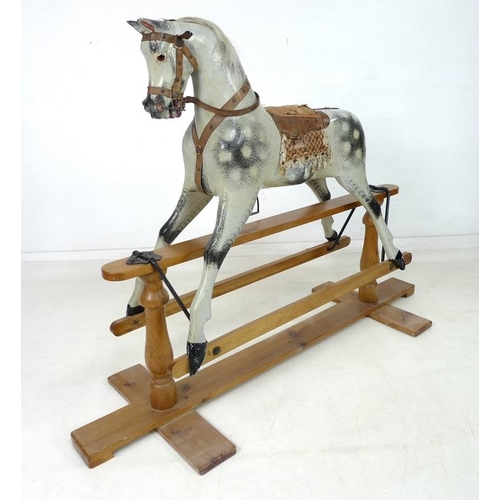 852 - An Edwardian rocking horse, the painted dappled grey body with leather bridle to head, leather and c... 