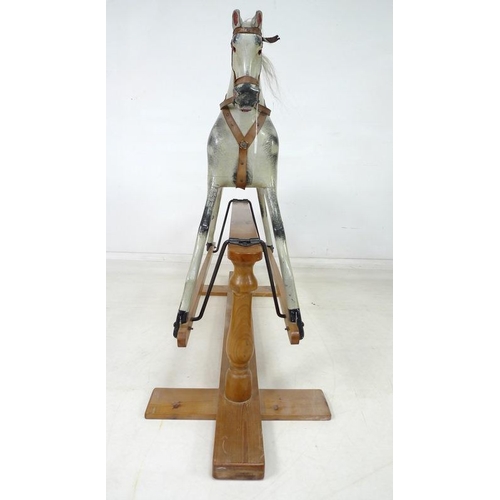 852 - An Edwardian rocking horse, the painted dappled grey body with leather bridle to head, leather and c... 