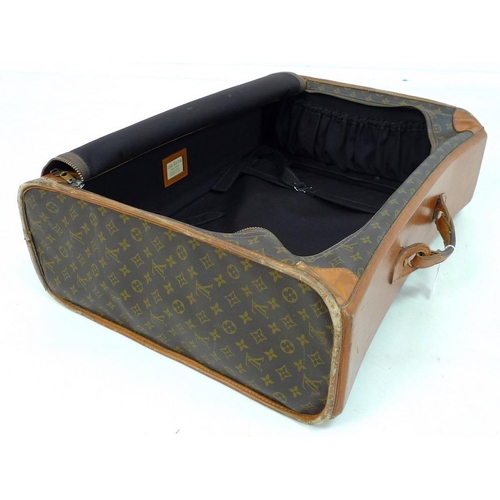 854 - A Louis Vuitton soft-sided travel bag, the leather top stamped with initials EDG, card label to inte... 