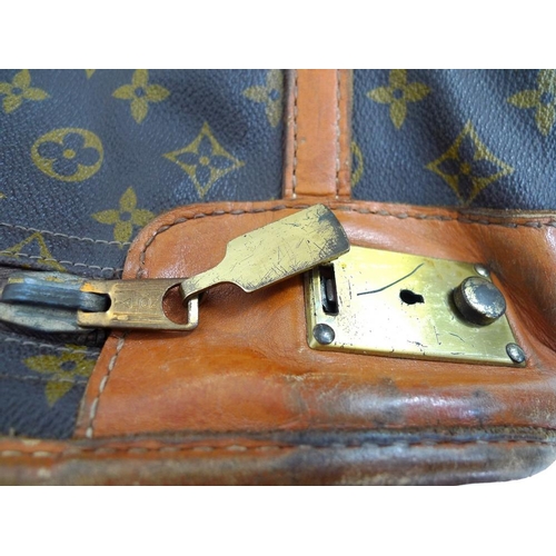 854 - A Louis Vuitton soft-sided travel bag, the leather top stamped with initials EDG, card label to inte... 