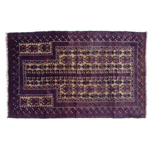 855 - A Baluchi rug with burgundy ground, dark blue, beige and cream geometric and latchhook decoration, 1... 