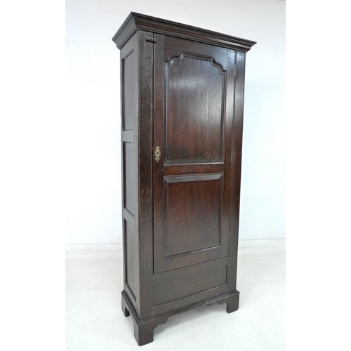 924 - A 19th century oak garderobe or narrow wardrobe, with single full length panelled door enclosing a h... 