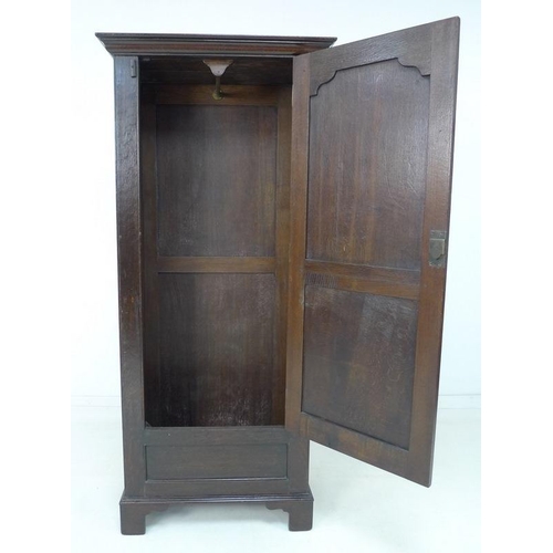 924 - A 19th century oak garderobe or narrow wardrobe, with single full length panelled door enclosing a h... 