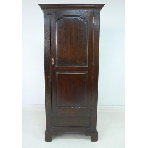 924 - A 19th century oak garderobe or narrow wardrobe, with single full length panelled door enclosing a h... 