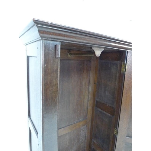 924 - A 19th century oak garderobe or narrow wardrobe, with single full length panelled door enclosing a h... 