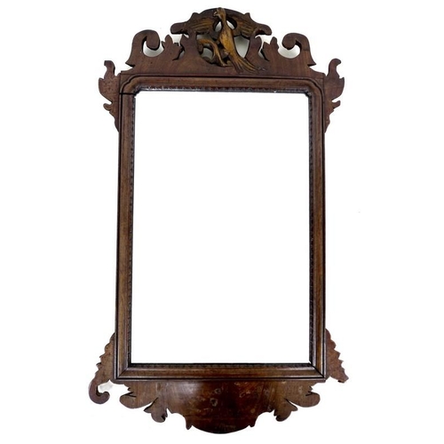 925A - A George III mahogany carved wall mirror, with eagle to the pediment amidst scrolling foliage and ca... 