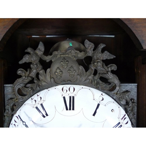 928 - A French 19th century oak tall long case clock, of tapering form with squared hood, the case carved ... 