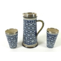 A Doulton Lambeth silver mounted stoneware jug and two beakers, late 19th century, decorated with mo... 