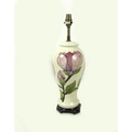 A Moorcroft table lamp, decorated in the Magnolia pattern, with later attached wooden stand, 34cm ta... 