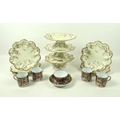 An early 20th century dessert service, possible Limoges, three comports with dolphin bases, moulded ... 