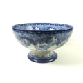 A Royal Doulton china punch bowl, decorated in flow blue with flowers and scrolling foliage, on circ... 
