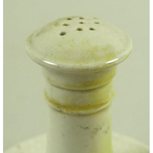 556 - An early 20th century Moorcroft pepper pot with integral saucer, with blush lemon yellow lustre glaz... 