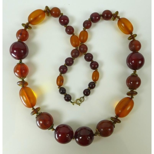 789 - An early to mid 20th century necklace with honey coloured amber and cherry coloured beads, hand knot... 