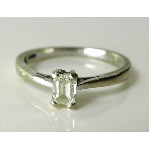 796 - An 18ct white gold and diamond solitaire ring, the emerald cut diamond approx 0.3cts, 4.4 by 3.3mm, ... 