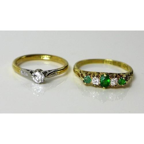 797 - An 18ct gold, emerald and diamond ring, the central oval emerald flanked by two diamonds and smaller... 