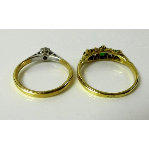 797 - An 18ct gold, emerald and diamond ring, the central oval emerald flanked by two diamonds and smaller... 