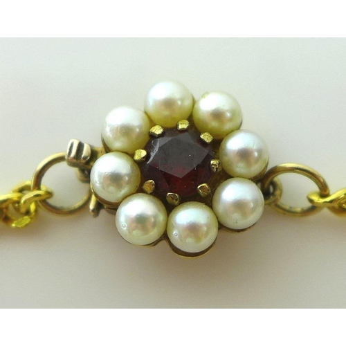 799 - A single strand of forty cultured pearls, with 9ct gold clasp set with a central garnet surrounded b... 