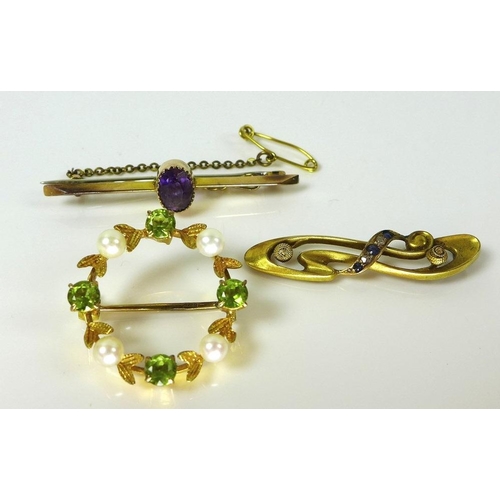 801 - A set of three gold brooches, comprising a 9ct gold bar brooch set with central oval amethyst, a sec... 