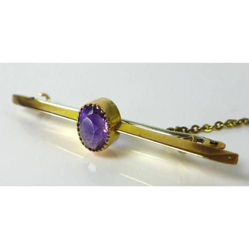 801 - A set of three gold brooches, comprising a 9ct gold bar brooch set with central oval amethyst, a sec... 