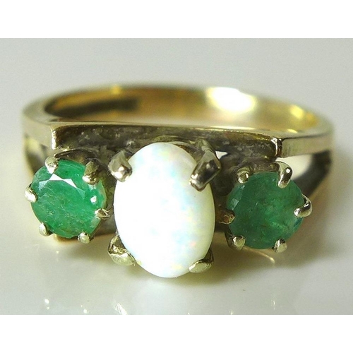 809 - An opal and emerald ring set in 9ct gold, early to mid 20th century design with splayed V shoulders ... 