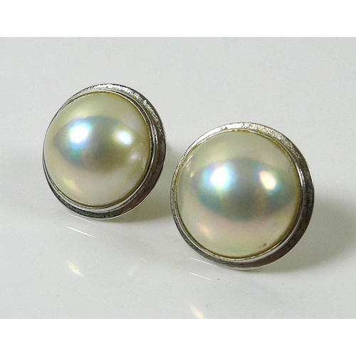 822 - A pair of 18ct white gold and faux pearl stud earrings, 15mm across, 5.1g total, in dark blue presen... 