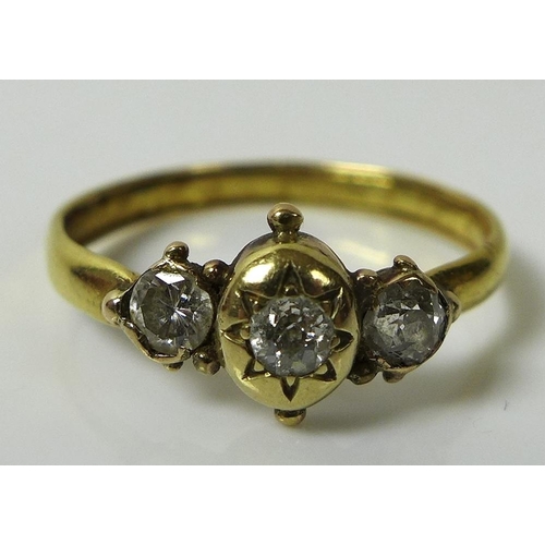 825 - An 18ct gold and diamond three stone ring, of unusual design, the central diamond of approximately 0... 