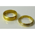 Two 22ct gold rings, one with inset platinum band to centre engraved with stars and lines, both mark... 