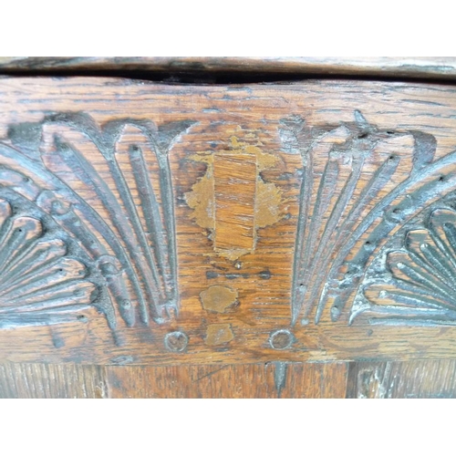 946 - A 17th century oak coffer with candle box and carved demi-lunettes to the four panel front, panel to... 