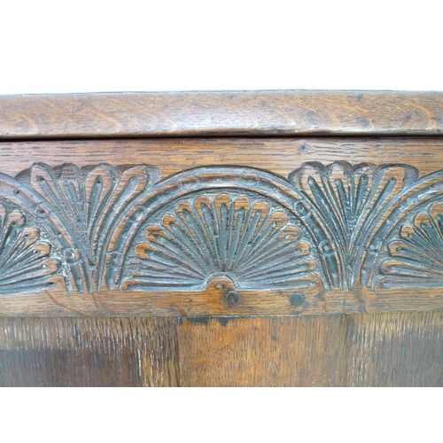 946 - A 17th century oak coffer with candle box and carved demi-lunettes to the four panel front, panel to... 