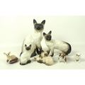 A group of Beswick figurines, comprising large sitting Siamese cat, 1882, 23.5cm, small sitting Siam... 
