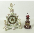 A Sitzendorf figural clock, circa 1890, modelled with three cherubin, 20cm high, together with an Au... 