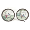 A pair of Chinese Republic period porcelain plates, decorated with two ladies at different artistic ... 