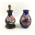 A Moorcroft vase of bulbous shape in anemone pattern on blue ground, impressed mark and initialled i... 
