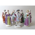 A set of Sitzendorf figures of King Henry VIII and his six wives, each with blue painted mark to the... 