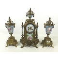 A French clock garniture with striking movement, and Roman numerals, the ceramic case richly decorat... 