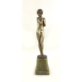 An Art Deco sculpture of a bronze model of a coy maiden, the nude figure modelled standing, after Jo... 