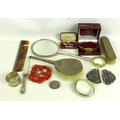 A collection of vertu and costume jewellery, including a white metal nurse's belt buckle, a Victoria... 