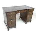 A 19th century mahogany kneehole desk, nine drawers with brass pull handles, dark red leather skiver... 