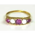 A 9ct gold ring set with alternating rubies and opals, with textured scroll setting, size R/S, 2.4g.
