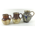 A group of three 19th century Doulton Lambeth ware jugs, comprising a polychrome jug with silver pla... 