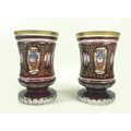 A pair of Bohemian flashed cranberry glass vases, 19th century, of cylindrical waited and footed for... 