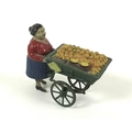 A tin and composition clockwork toy figure, early 20th century, modelled as an orange seller with ca... 