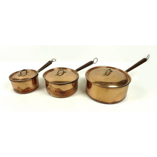 711 - A collection of items including a set of three copper saucepans with lids and a Victorian antler han... 