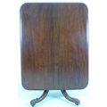 A Victorian mahogany breakfast table of rectangular form on four legged pedestal base with baluster ... 