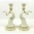 A pair of Royal Worcester porcelain candlesticks, circa 1890, shape 1056, modelled as a mirrored pai... 