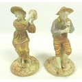 A pair of Royal Worcester porcelain figurines, circa 1898, modelled as the boy piper Strephon and co... 